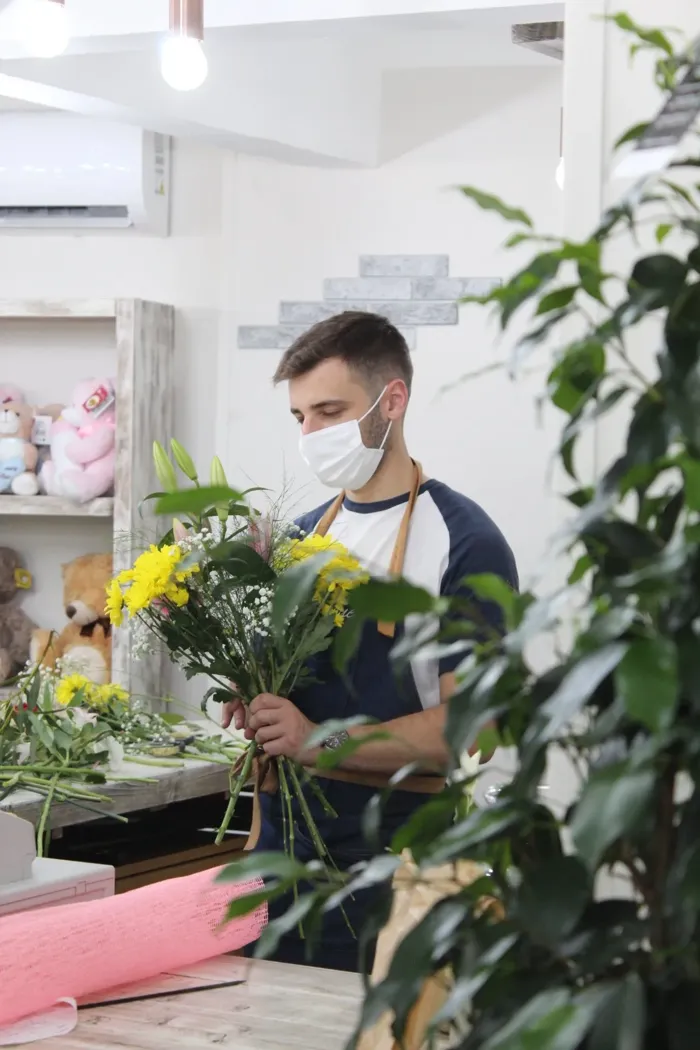 Florista montando un ramo en la tienda